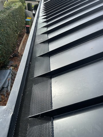 installed steel gutter guard on metal roof